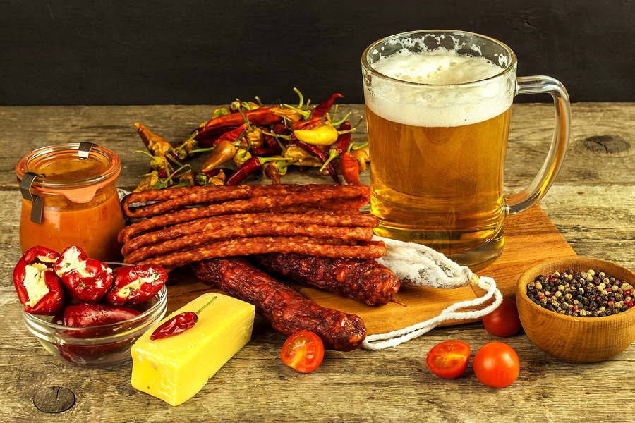 Beer And Sausages On An Old Wooden Table. Sale Of Beer And Sausa