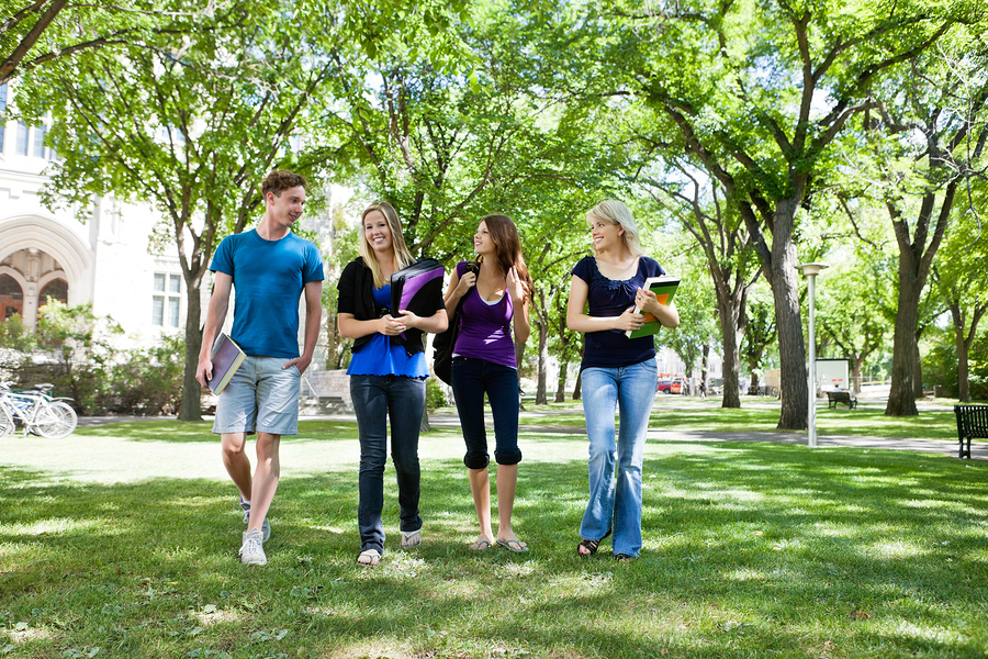 Group of college students walking in campus ground