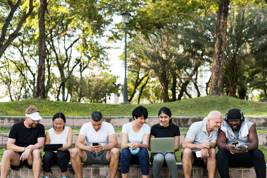 Group of diverse people using digital devices