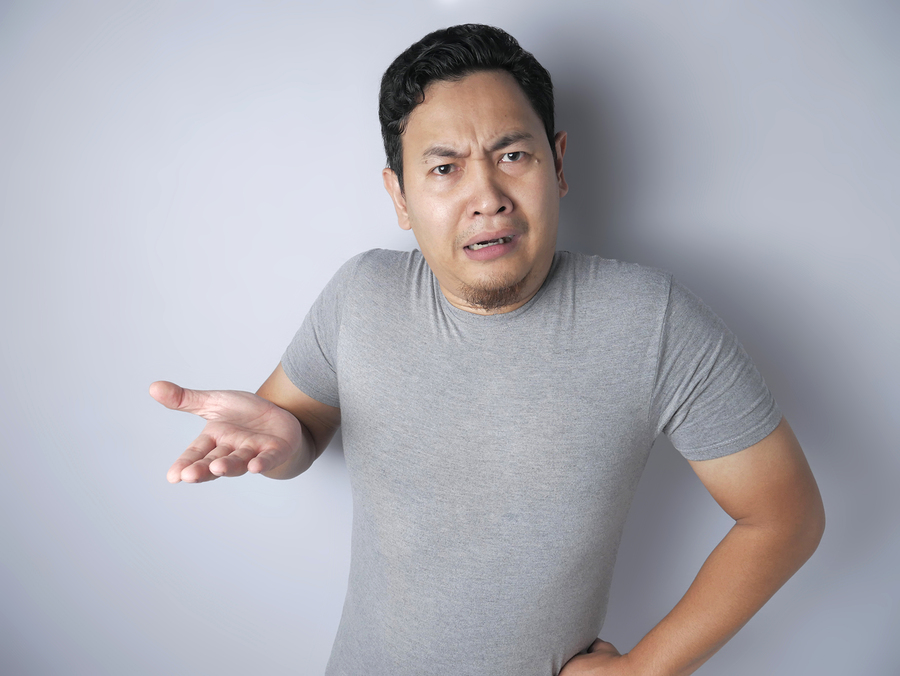 Portrait of young Asian man feels disappointed, upset and argue looking at camera, denial gesture